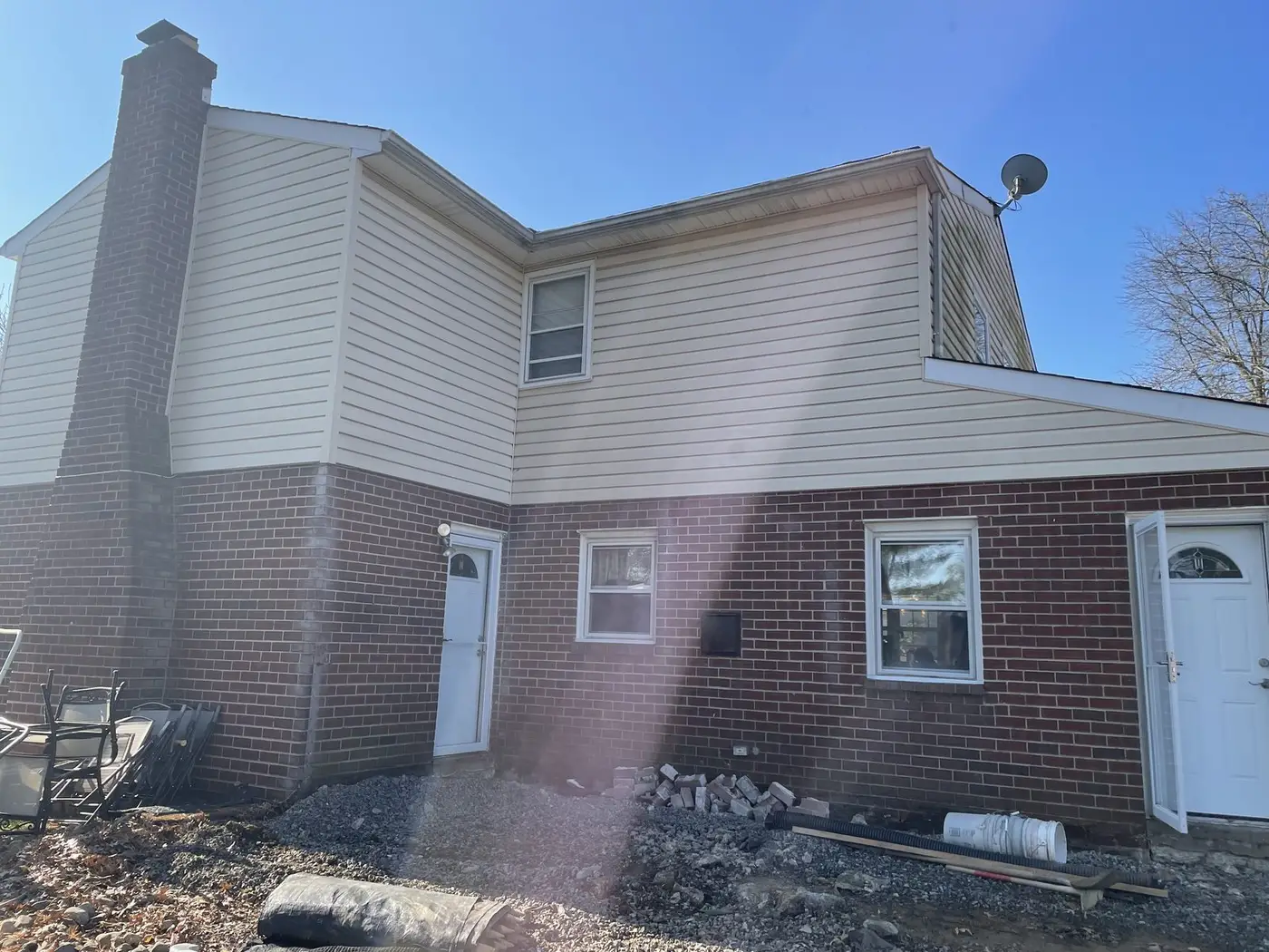 Rear of a brick and siding house in Huntingdon Valley, PA before the addition work began