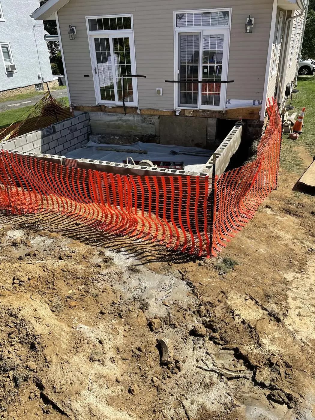 Foundation forms and orange safety fence at the rear of the house before the addition went up
