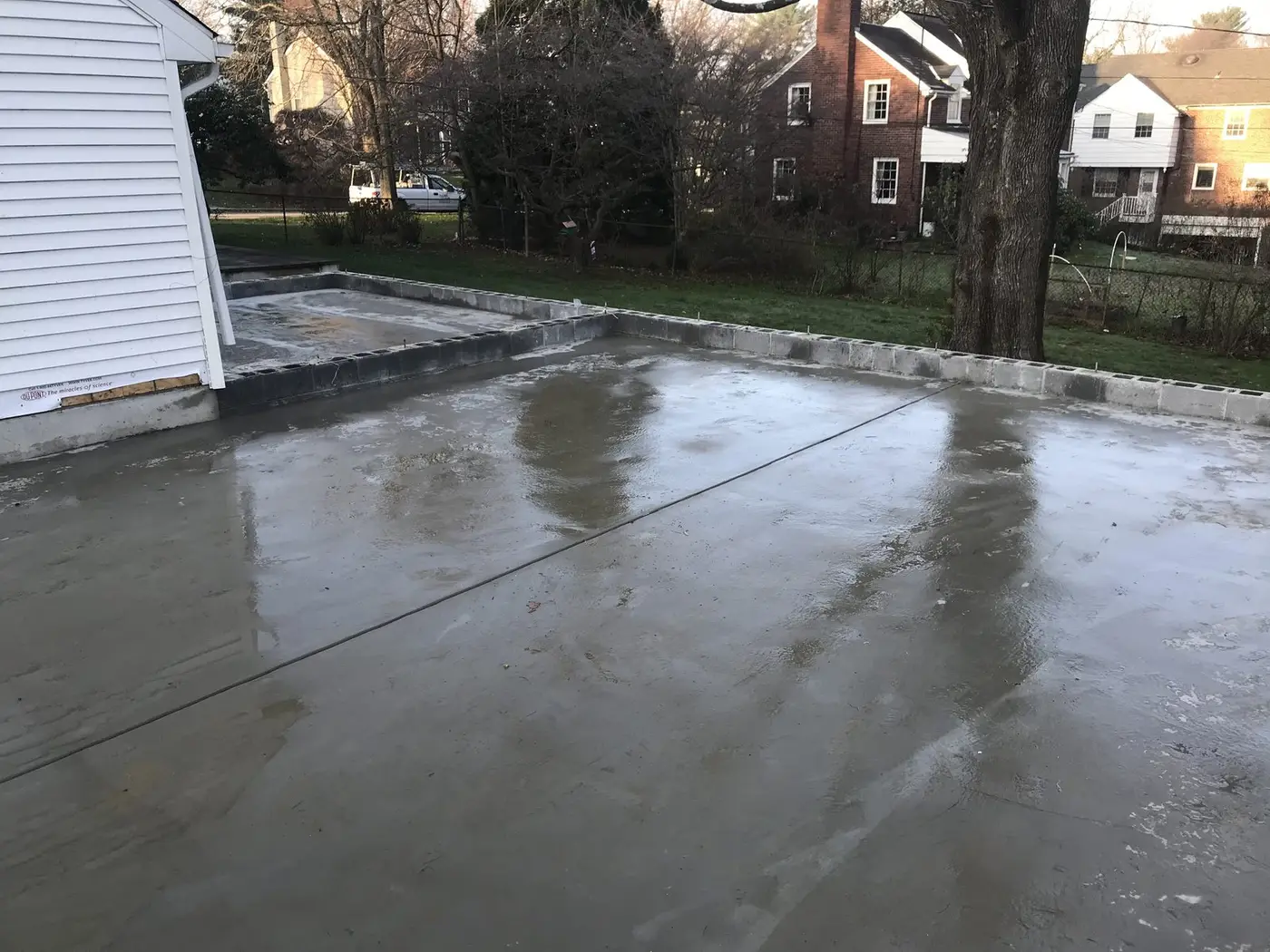 Freshly poured concrete slab for the garage and suite, still wet